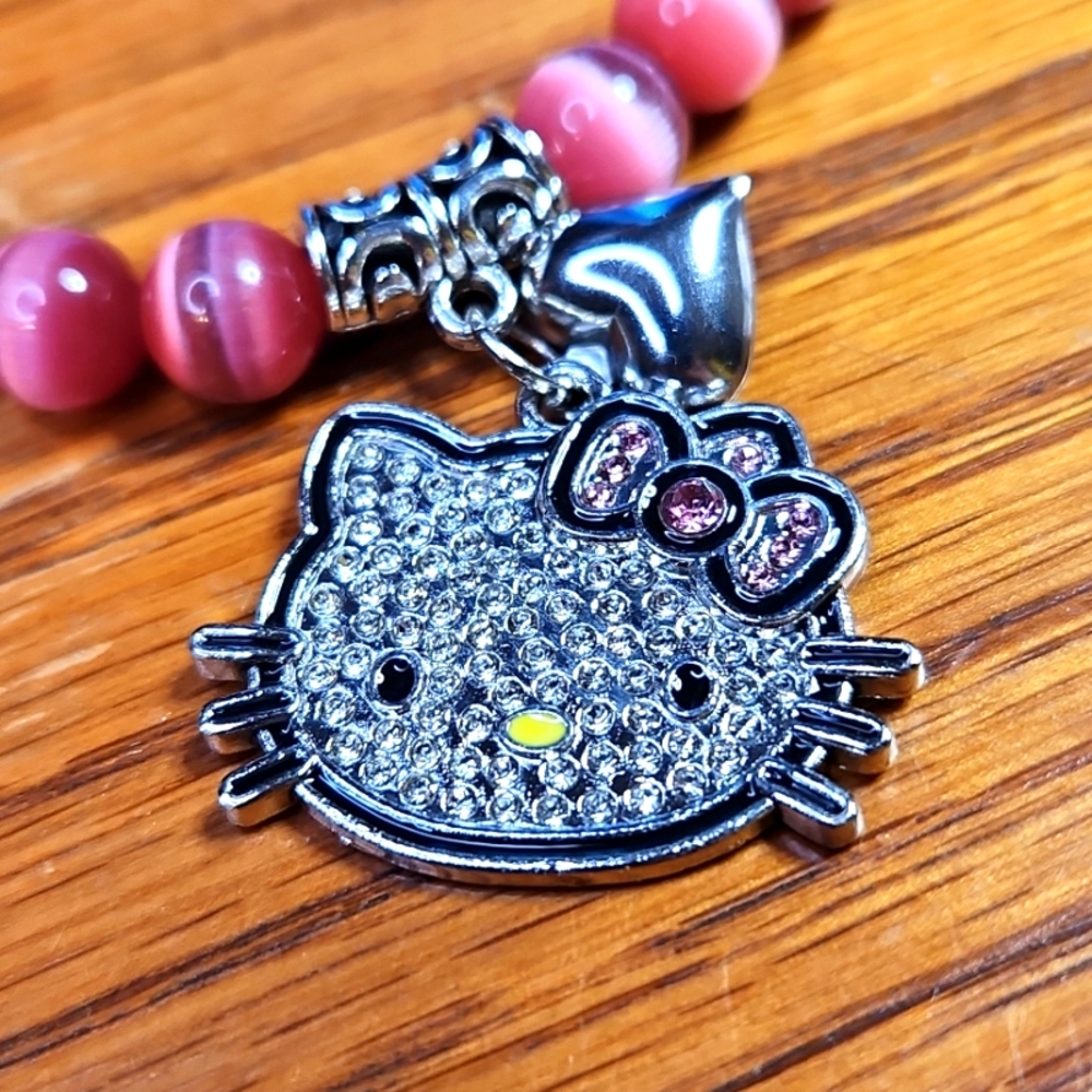 NWT Luminous "Hello Kitty" Pink Cat Eye Stretch Bracelet - Picture 2 of 3